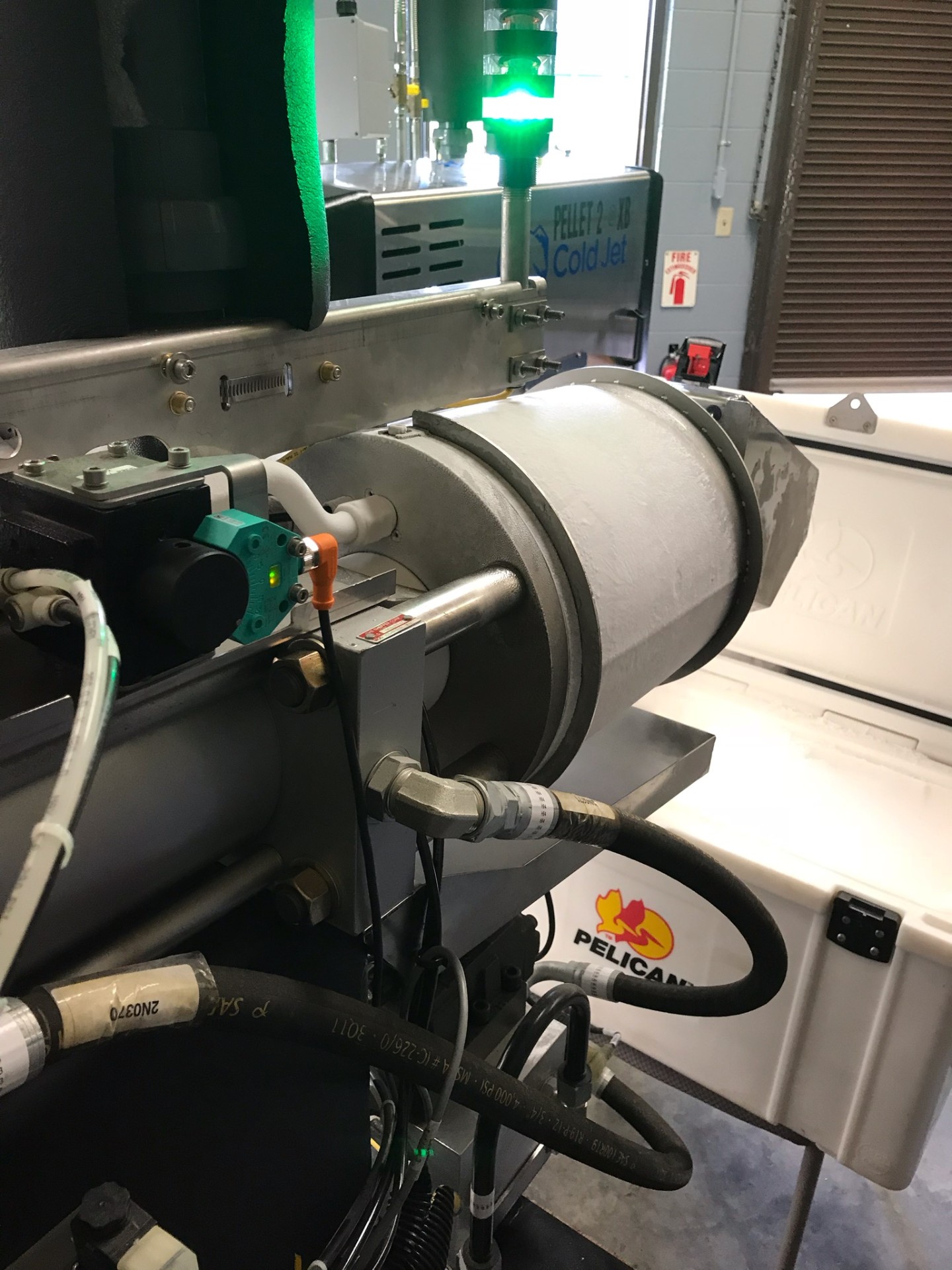Cold Jet pellet press with revert recovery piping in a Dibshawaii production room